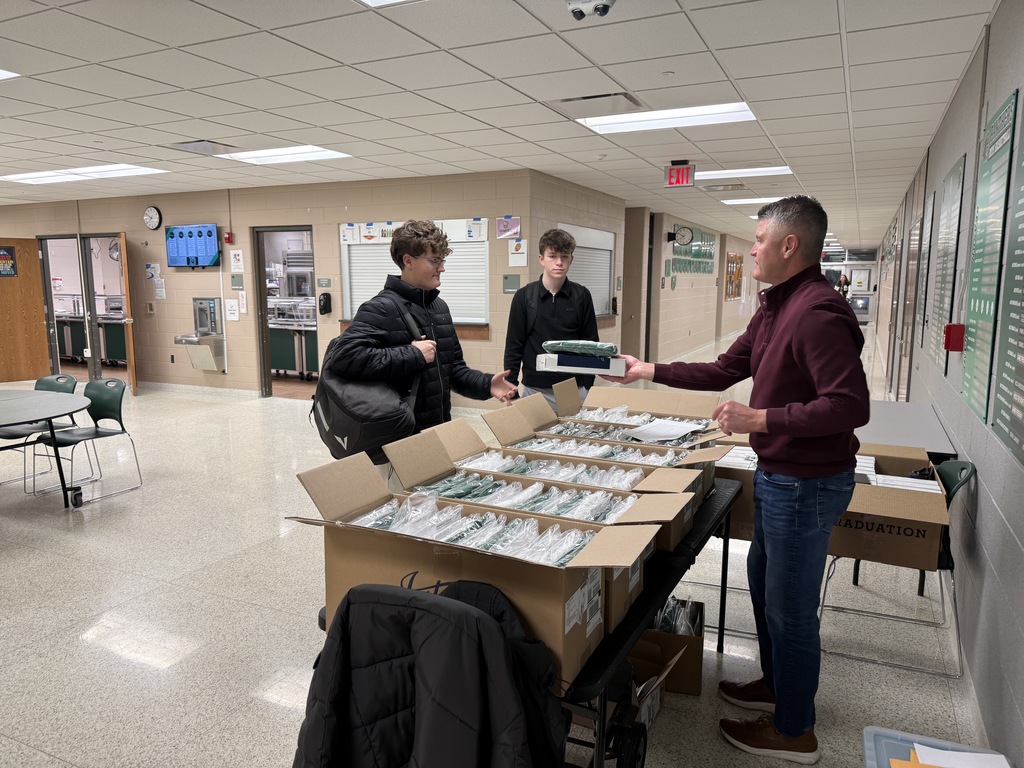 Students picking up graduation materials
