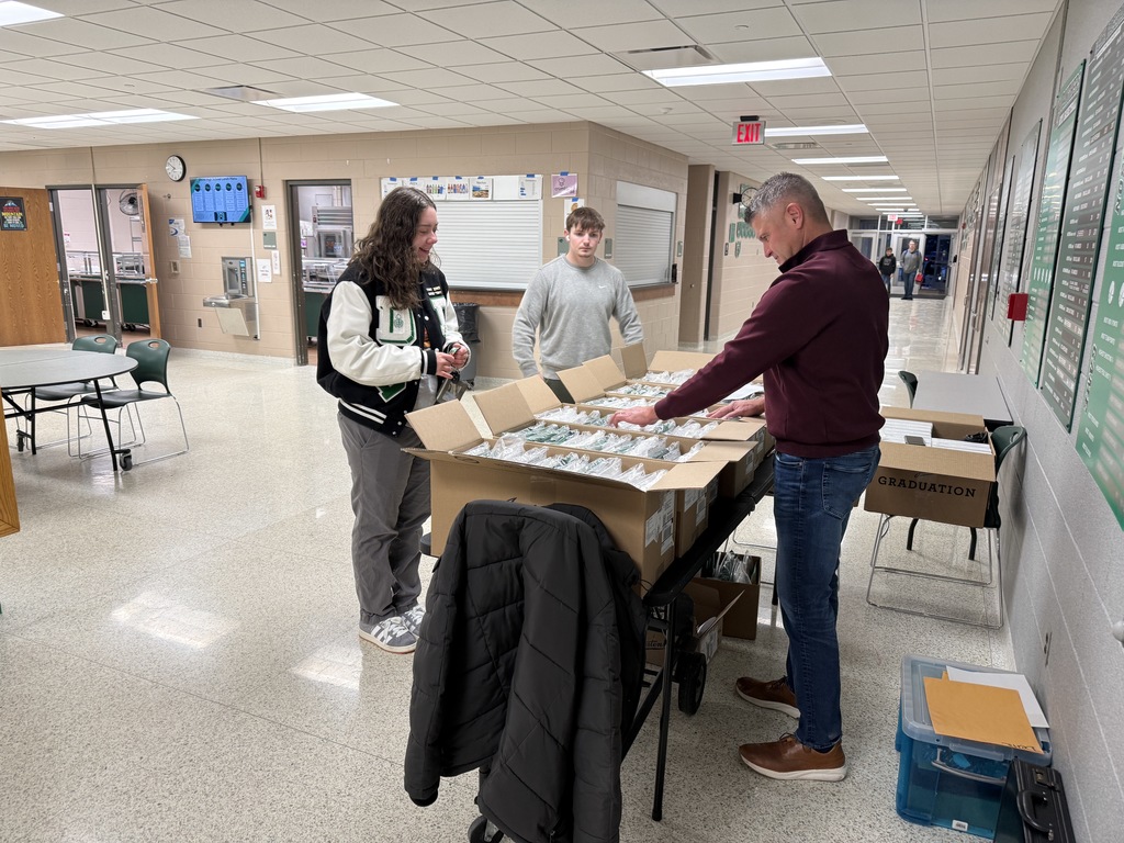 Students picking up graduation materials