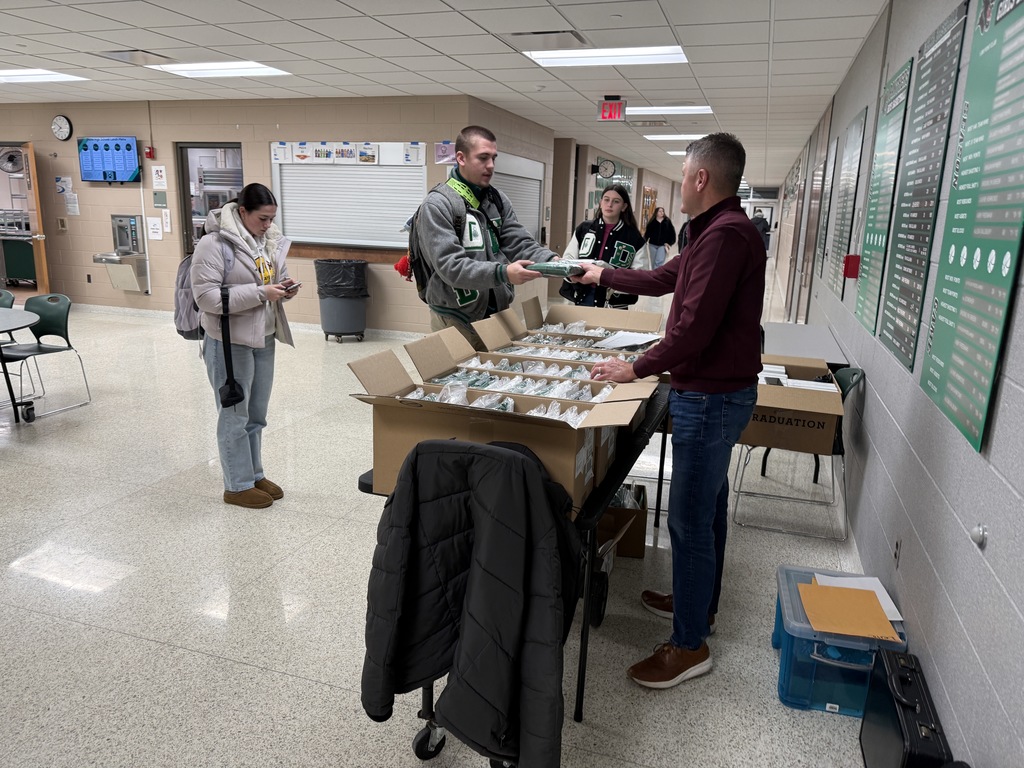 Students picking up graduation materials