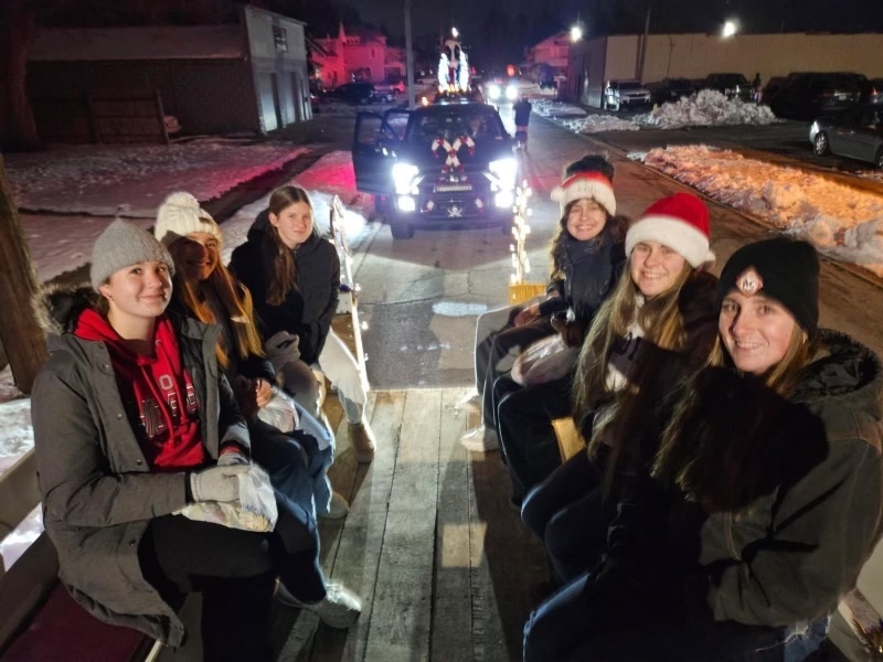 Students sitting on a float in a parade