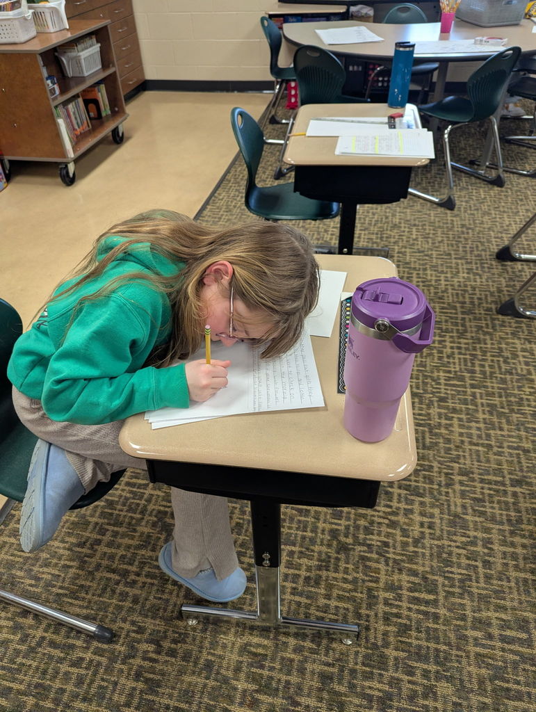 Students writing in a classroom