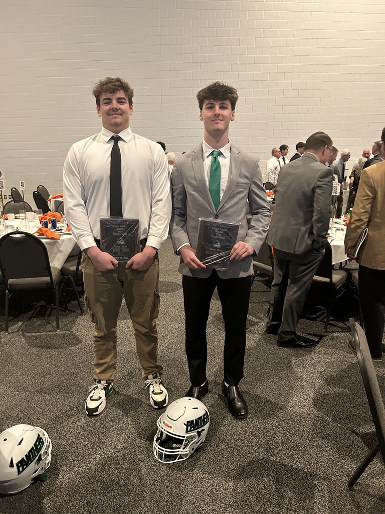 two athletes posting for a photo