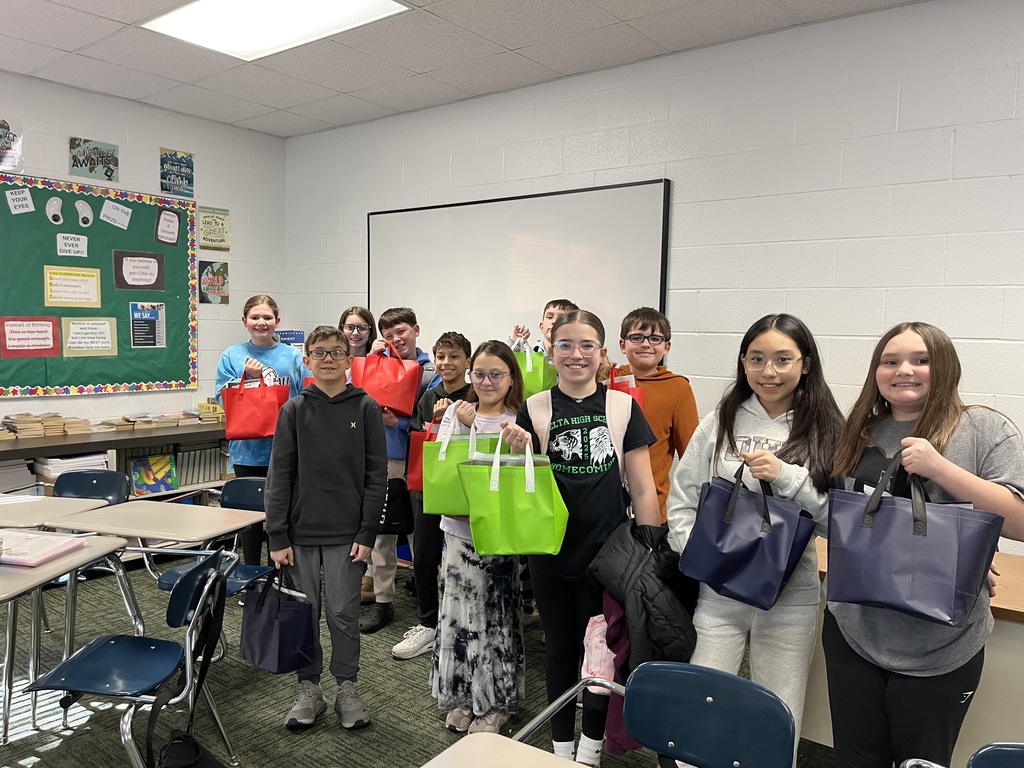 students posing after collecting canned goods