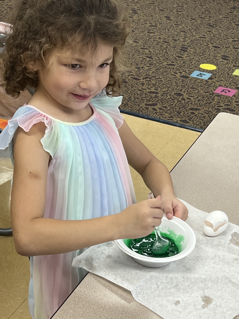 A student eating green eggs and ham