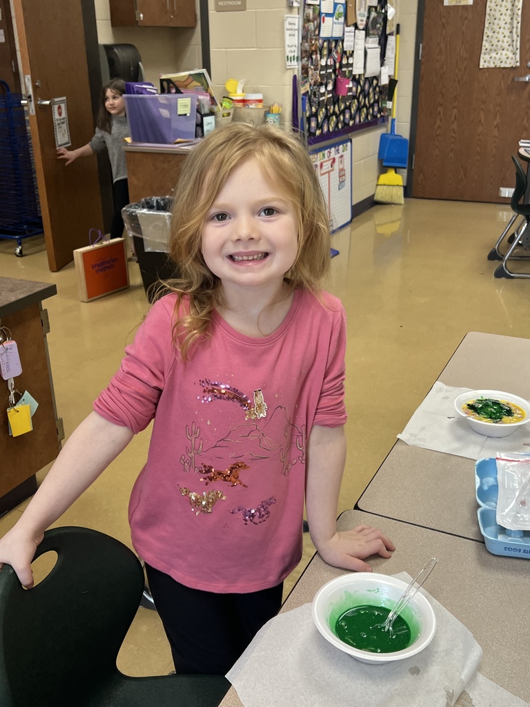 A student eating green eggs and ham
