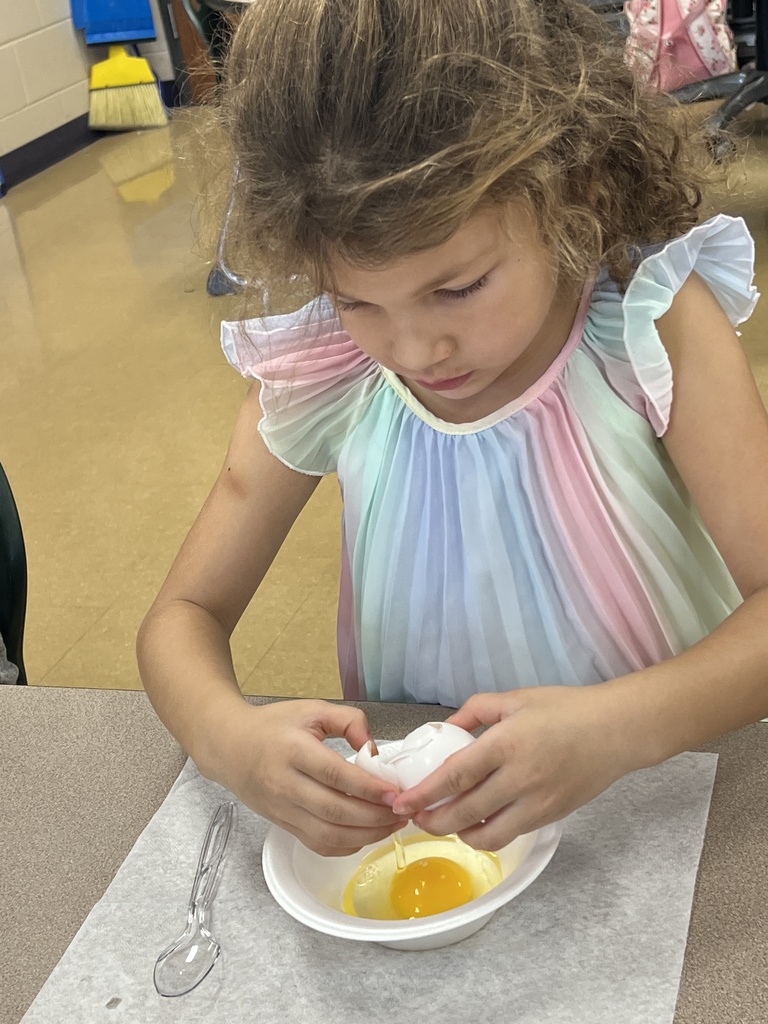 A student eating green eggs and ham