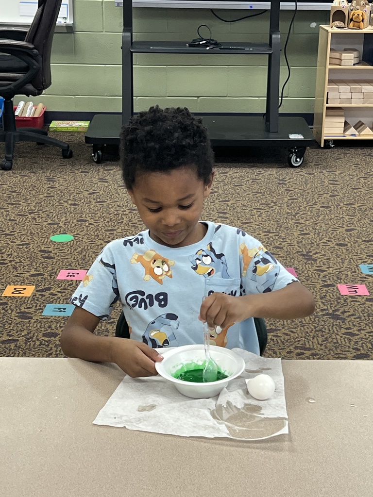 A student eating green eggs and ham