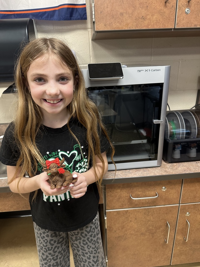 A student holding a highland cow figurine