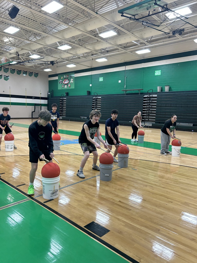 students cardio drumming in a gym