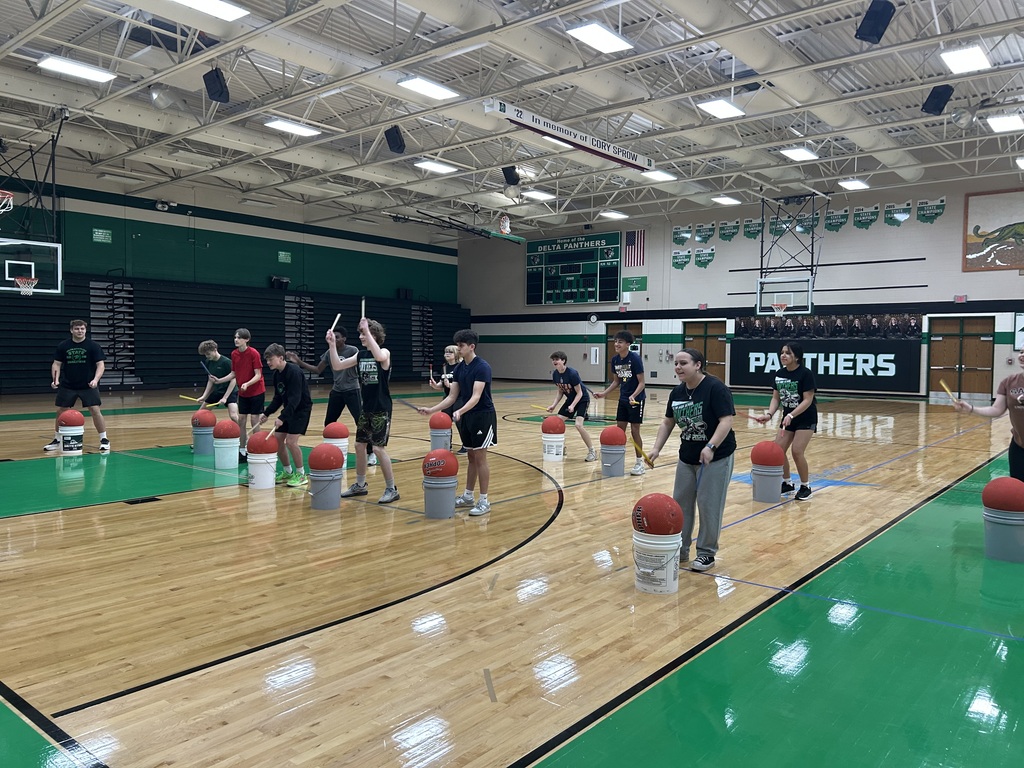 students cardio drumming in a gym