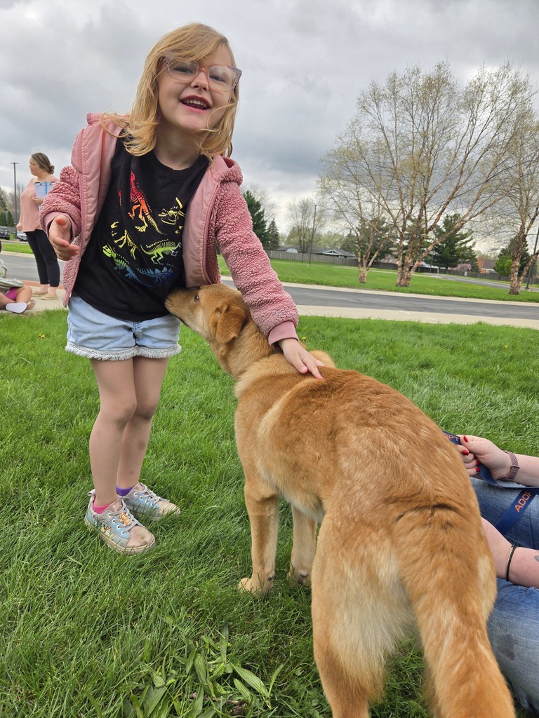 a student petting a dog