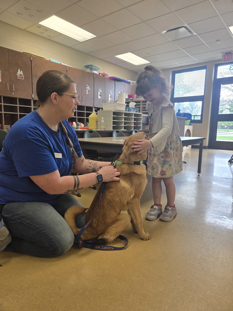 a student petting a dog