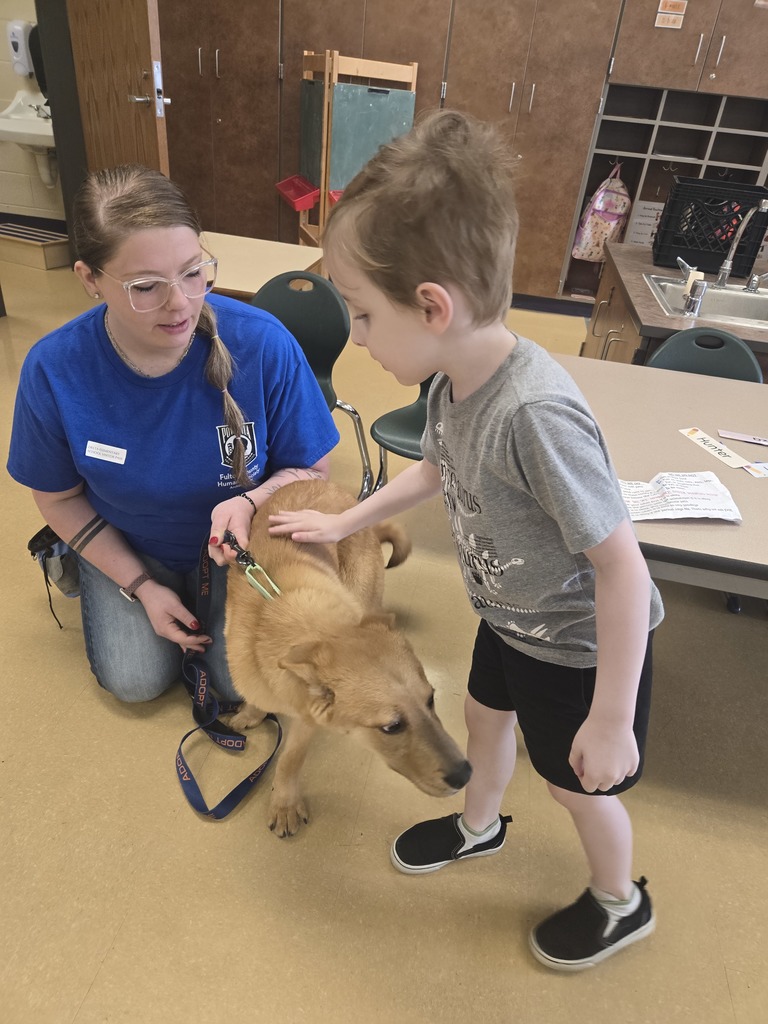 a student petting a dog