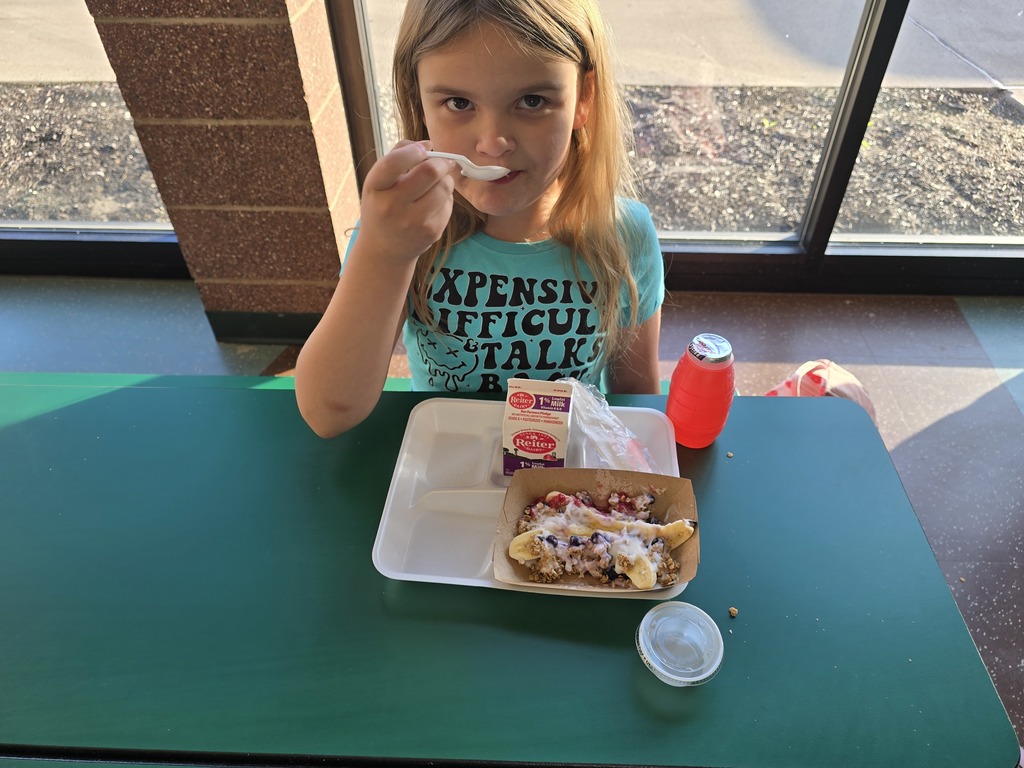 a student posing with their yogurt banana splits