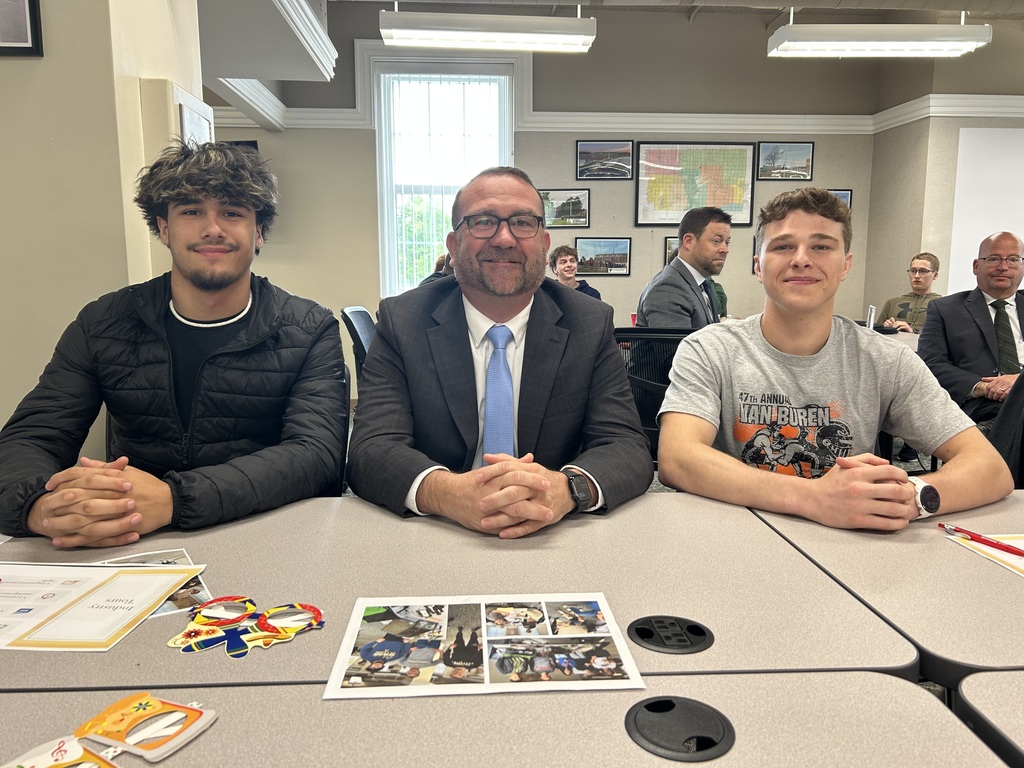 two students posing with their principal