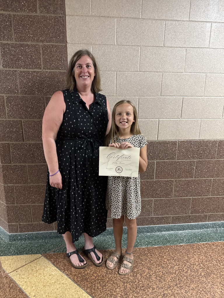 a student standing with her principal