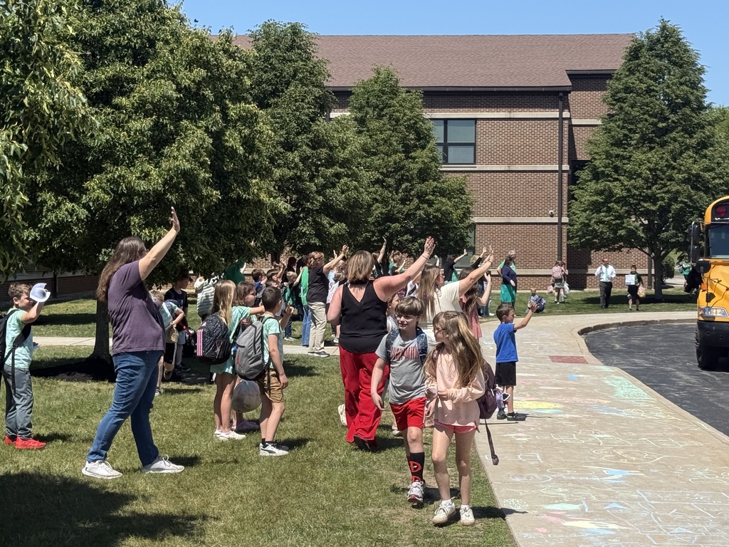 Teachers waving to students on the last day of school