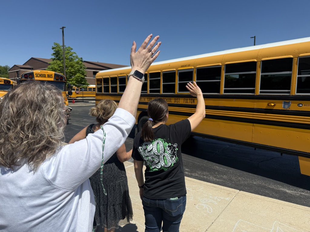 Teachers waving to students on the last day of school