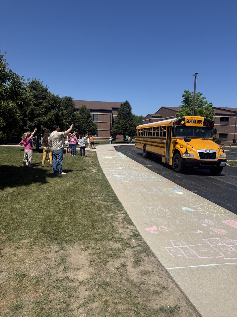 Teachers waving to students on the last day of school