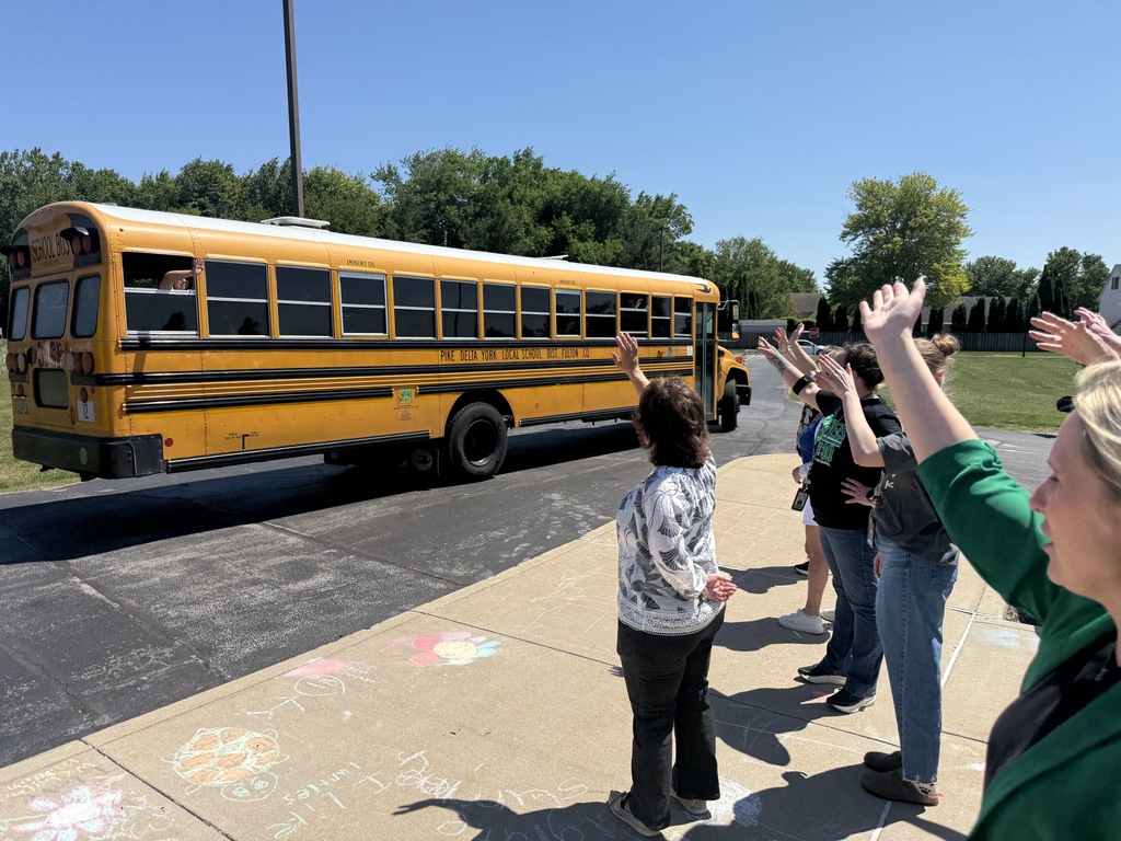 Teachers waving to students on the last day of school