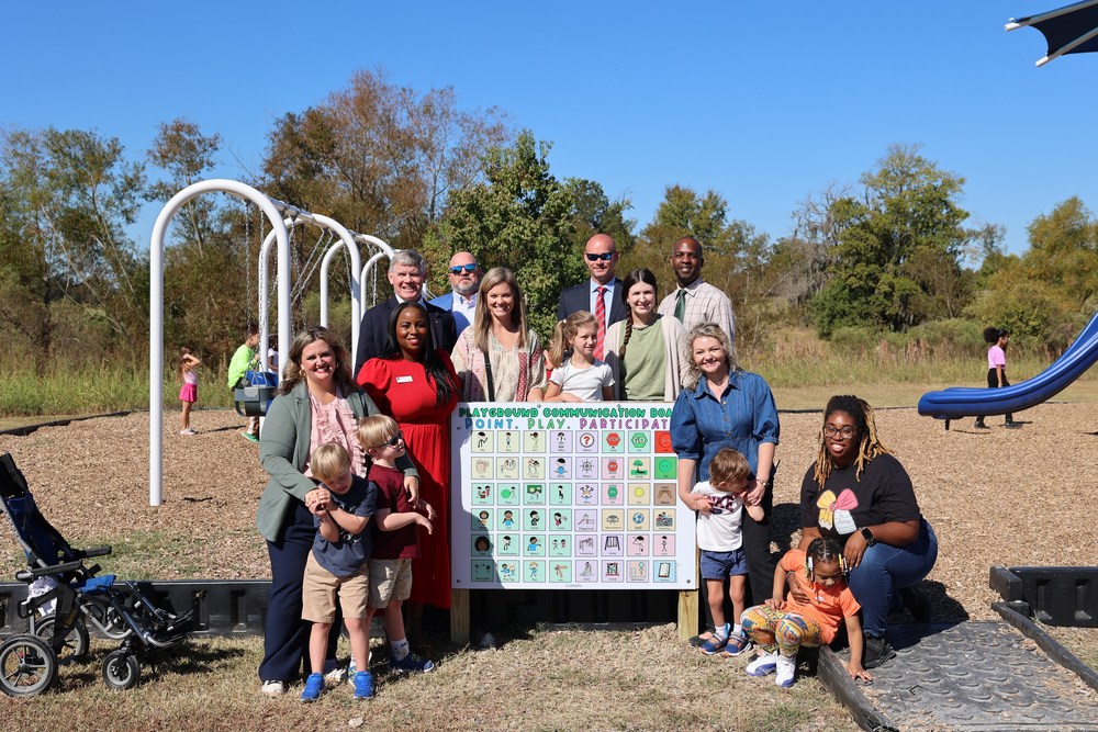 Students, Teachers, and Community Members with new communication board on Elementary School Playground