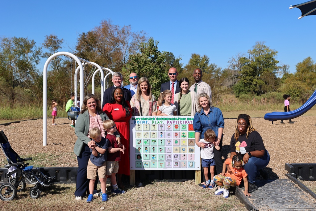 Students, Teachers, and Community Members with new communication board on Elementary School Playground