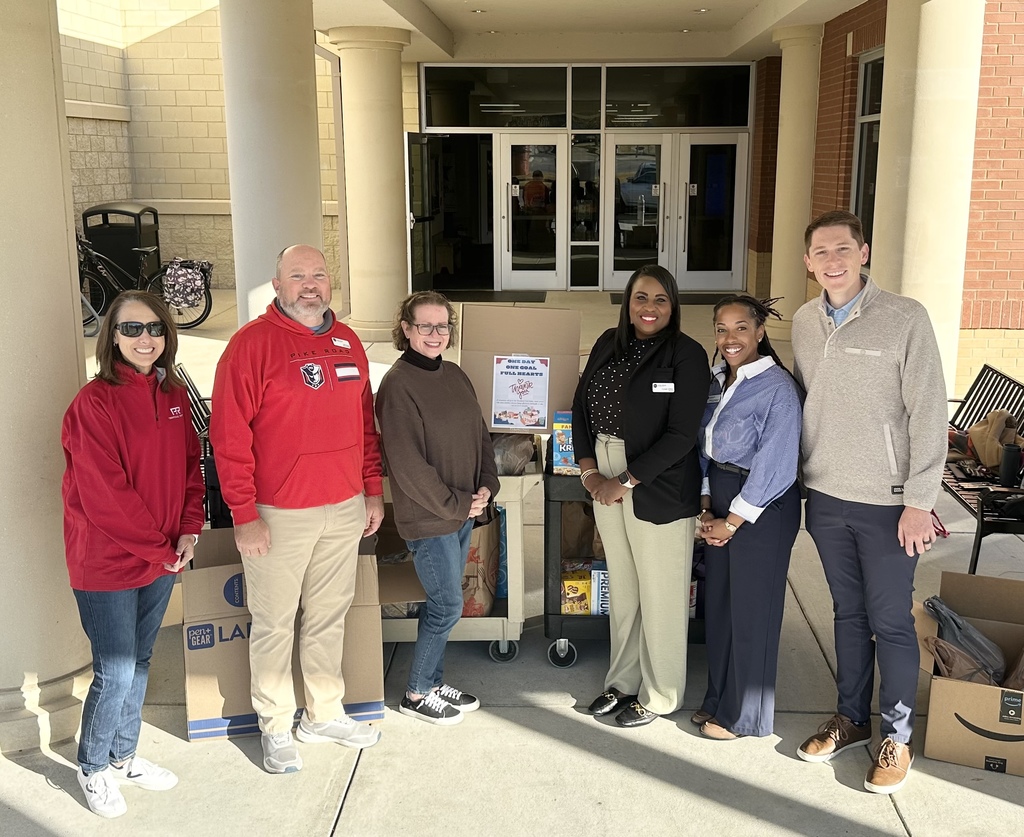 Amanda Williamson, Jeff Dickey, Carmen Upton, Cyndal Whiten, Daisha Henderson, & Parker Reiss gather around the food donated at the elementary school this morning.