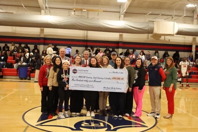 AP Teachers posing with their check