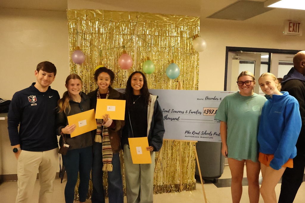 Five students holding gift cards in front of check