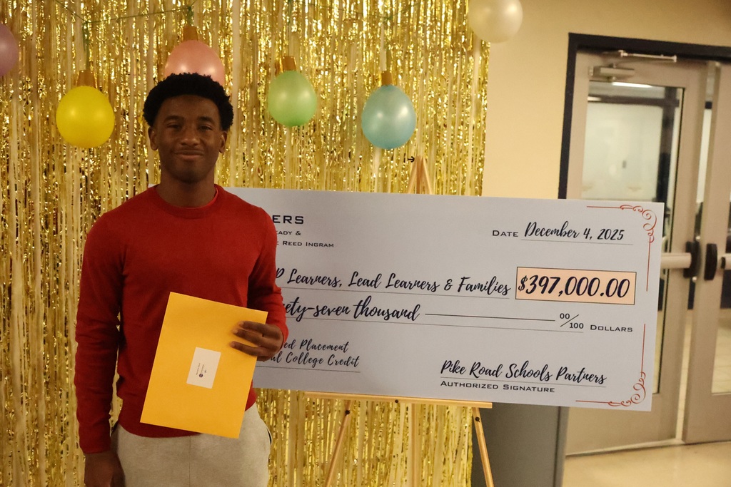 Student holding gift card in front of check