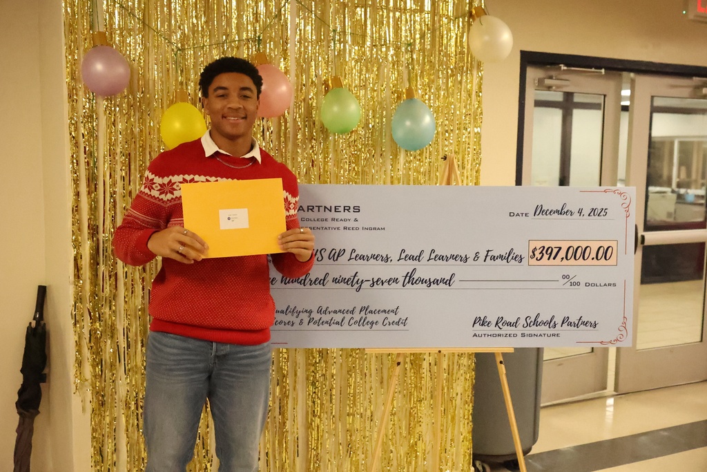 Student holding gift card in front of check