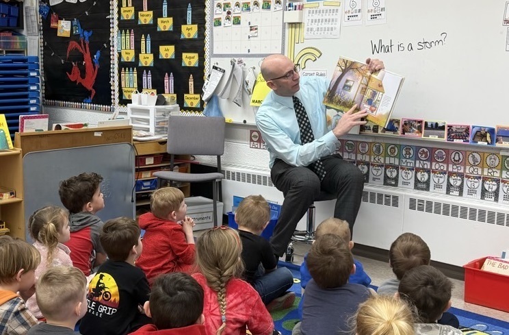 Adult reading to students