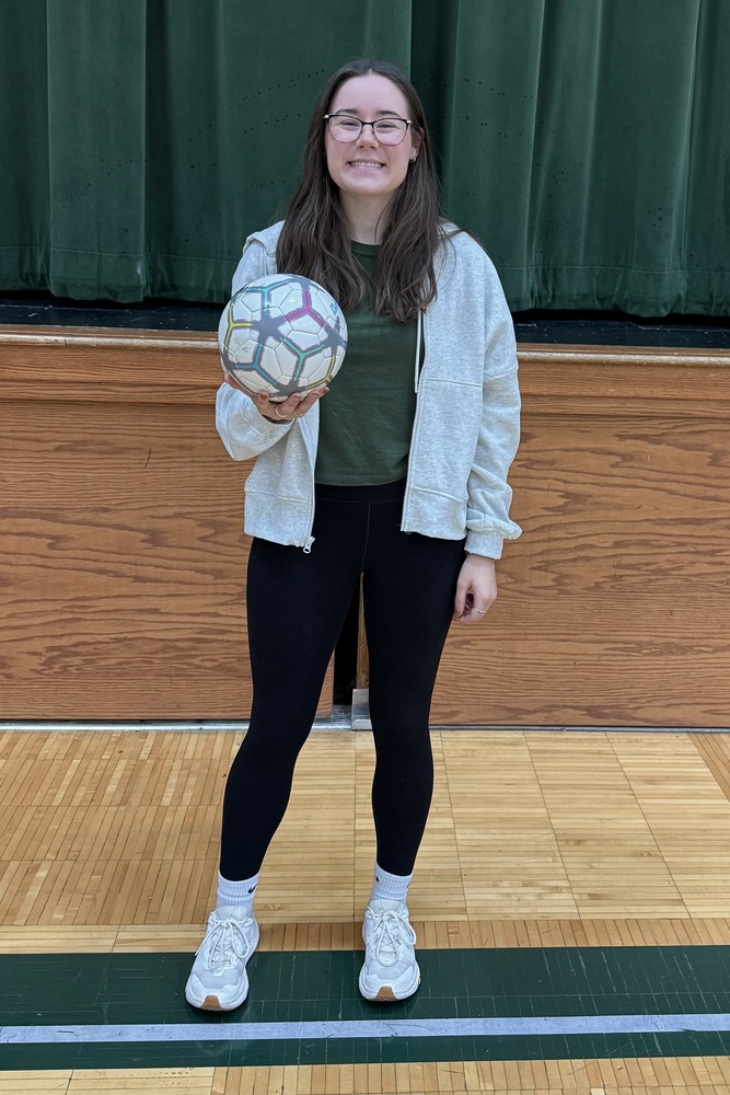 Ms. Cartier holding a soccer ball