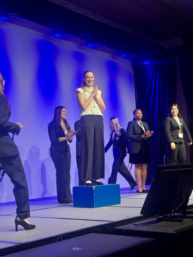 Chloe Drouose accepts gold on stage at HOSA