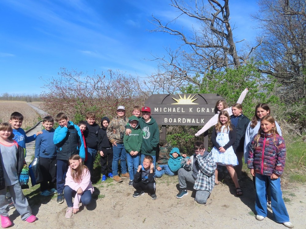 Students near boardwalk sign