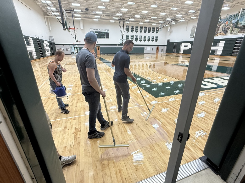 Custodial Crew waxing the gym floor