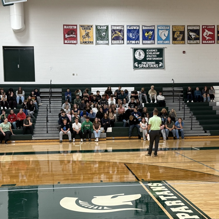 PHS Principal talks to students in the gym bleachers.