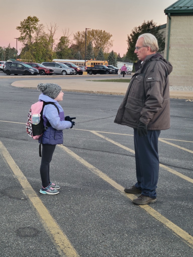 John sanford in the parking lot with a student