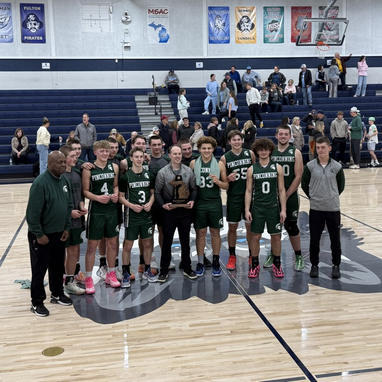 Boys basketball team holding district championship trophy