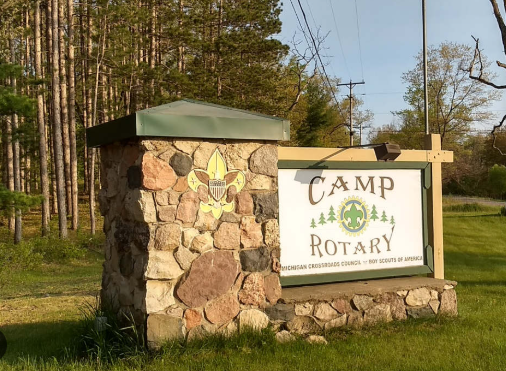 Stone pilar with Camp Rotary Sign.