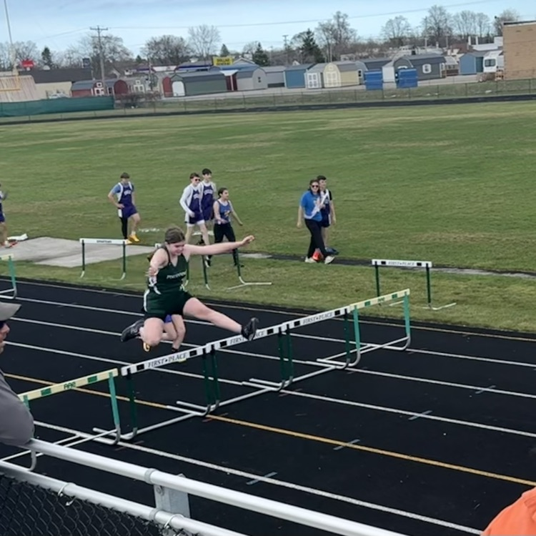 student jumping hurdles
