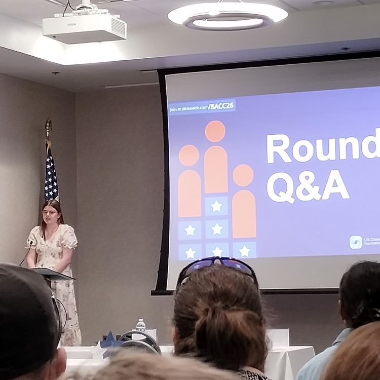 Megan at the podium speaking