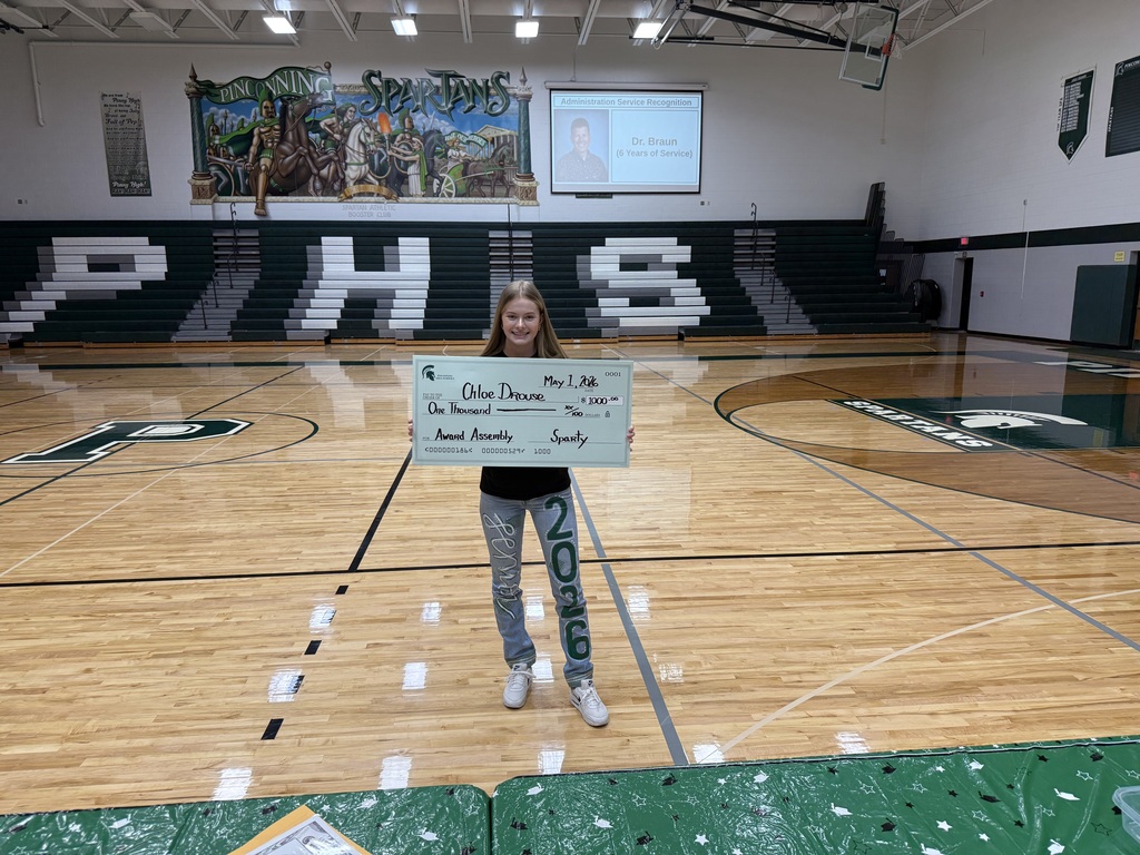 Student holding big check
