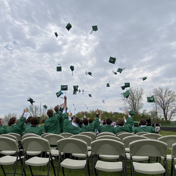 Grads toss their caps.