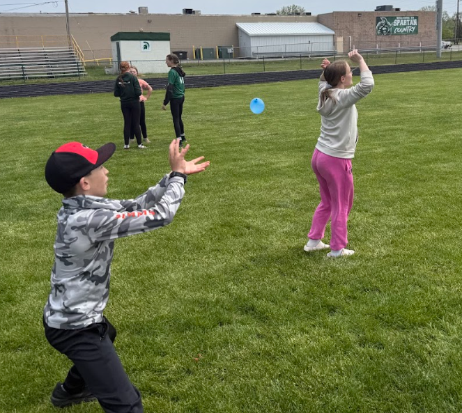 Students playing water ballon toss