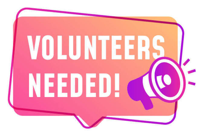The words volunteers needed with a megaphone