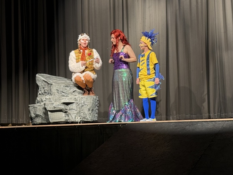 Skuttle, Ariel, and Flounder on stage