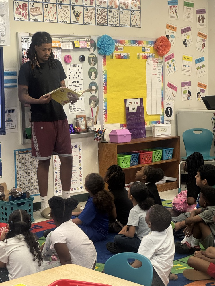 UAPB athlete reading to scholars.