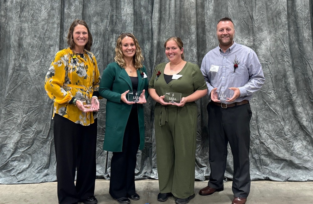 Four Pine City educators posing with their LEEA Award Plaques, at event in St. Cloud MN