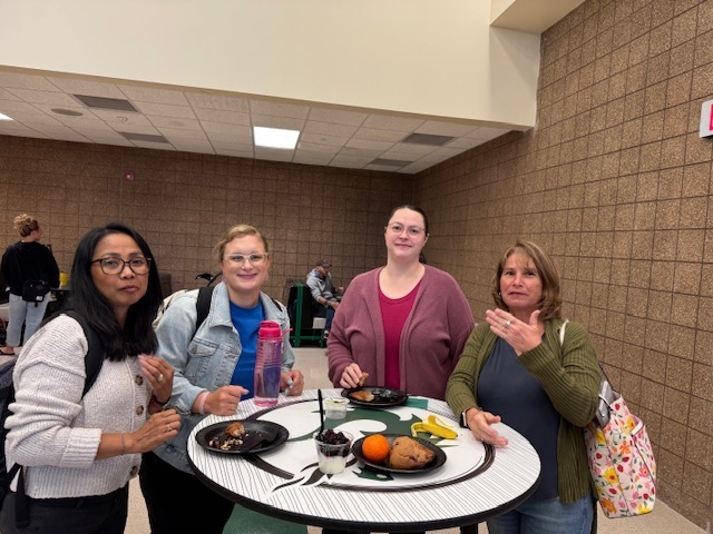 Elementary staff members enjoy a light breakfast before the district kick-off